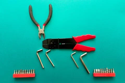 Conceptual set of tools on green background. It looks like a deer. Working ha Stock Photos