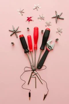 Conceptual set of tools on pink background. It looks like bouquet of flowers  Stock Photos