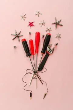 Conceptual set of tools on pink background. It looks like bouquet of flowers  Stock Photos