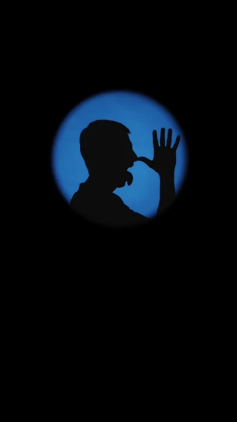 Conceptual silhouette of a funny man pulling a silly face in blue circle sp.. Stock Footage 334629854