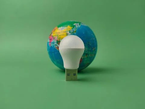 A conceptual studio shot featuring a small white USB LED light bulb standin.. Фото