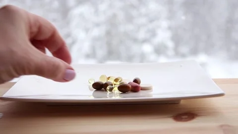 Conceptual video of taking vitamins in wintertime. Stock Footage 147596157