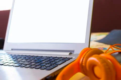 Conceptual workspace. Laptop with the screen in white. Stock Photos
