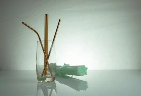Conceptual of world issue on single use plastic against reusable steel straw. Stock Photos