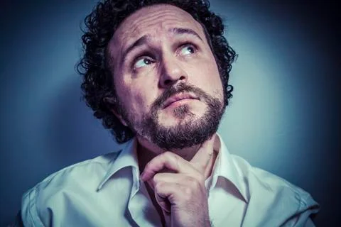 Concern for the future, man with intense expression, white shirt Stock Photos