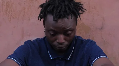 Concern, problems - discouraged black man in the street with bowed head Video stock 240329633