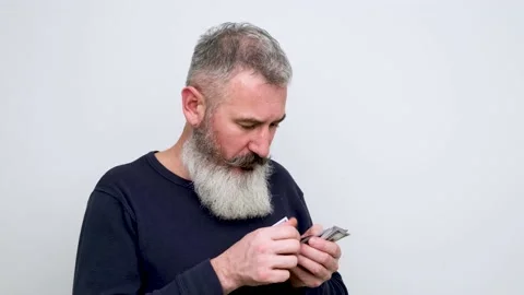 Concerned bearded man counting dollar banknotes, budget concept Stock Footage 147996117
