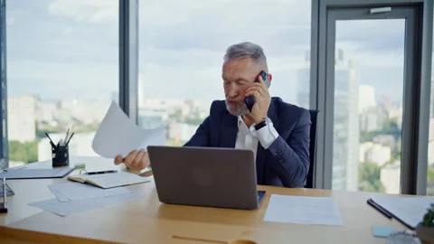 Concerned boss complaining smartphone call on document mistake in office closeup Stock Footage 319964751