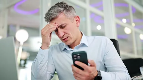 Concerned Businessman Checking Mobile Phone and Thinking in a Modern Office Stock-Footage 311973255