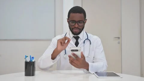 Concerned Doctor Using a Smartphone Stock Footage 310167617