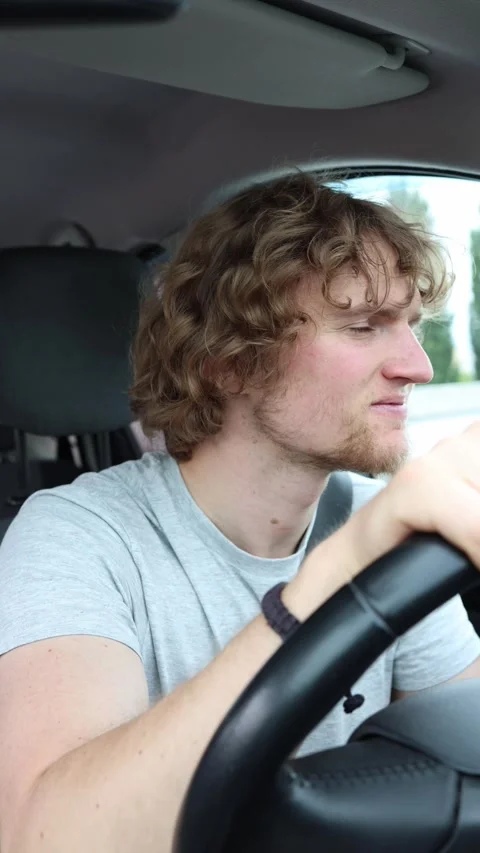 Concerned driver listens for a strange rattling noise inside the moving car Stock Footage 342922568