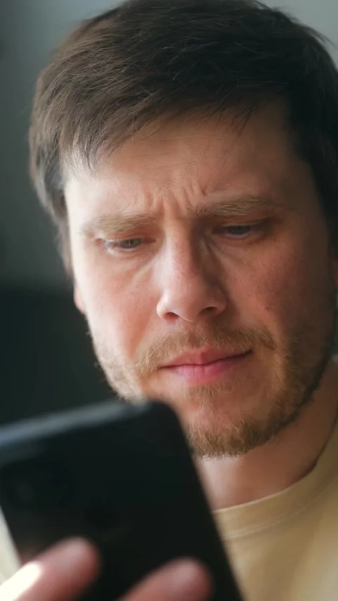 Concerned man browsing social media on smartphone Stock Footage 337892373