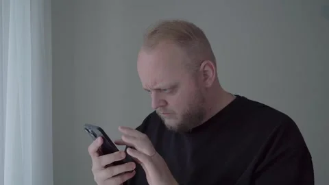 Concerned Man Reacting to Weak Password Security Alert on Smartphone Stock Footage 342667220