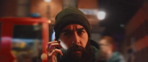 Concerned man talking on the phone with a fire truck lights in the background Video stock 203583642