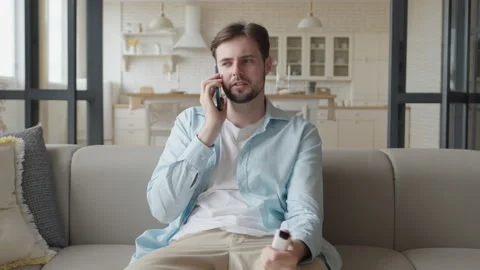 Concerned Man Talking On Phone, Holding Medicine Bottle, Seeking Medical Advice Stock Footage 303759367