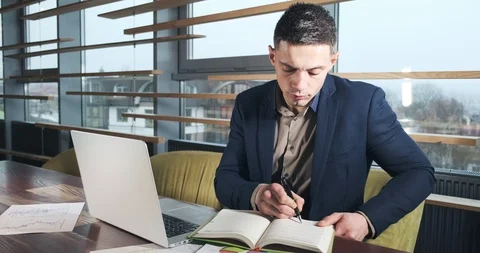 Concerned man working on laptop computer and looking away thinking solving Stock Footage 122537603