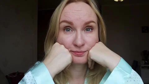 Concerned middle aged woman touching forehead wrinkles and frown lines between e Stock Footage 343732845