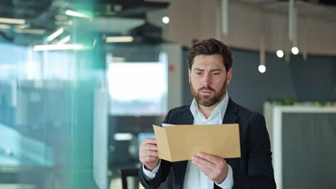 Concerned Professional Reads Important Document in Modern Office Stock-Footage 329091327