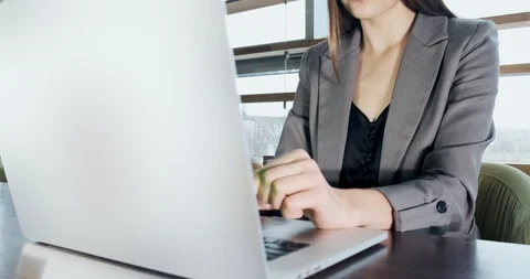 Concerned woman working on laptop computer and looking away thinking solving Stock Footage 121527709