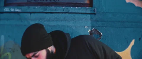 Concerned young man grabbing his backpack from the floor while stares a police Stock Footage 203584104