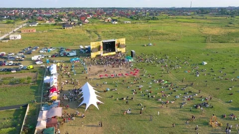 Concert among the fields on the background of the village and the sunset Stock Footage 158609144