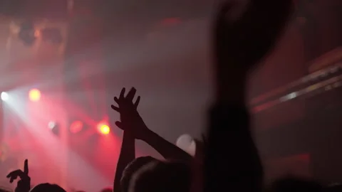 Concert Crowd Cheering, Hands Up Under Red Stage Lights Stock Footage 334484985