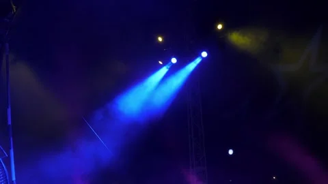 Concert equipment with multi colored spotlights in the dark of the circus arena. Stock Footage 308470976