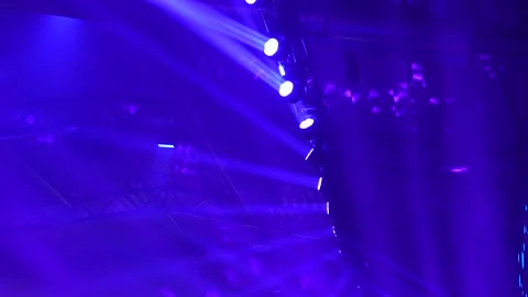 Concert lighting rig generating dramatic beams and atmospheric color patterns Stock Footage 322153359