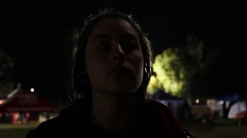 Concert lights flash on teens face Stock Footage 80073812