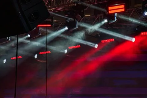 Concert stage with dramatic red lighting, elevated platform, smoke, and gre.. Stock Photos