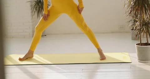 Concetrated female yoga practitioner doing a warrior position. Fit athletic girl Stock-Footage 154332874