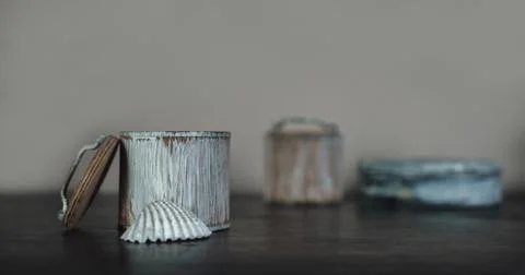 Conch and the small boxes on the old brown wooden table Stock Photos