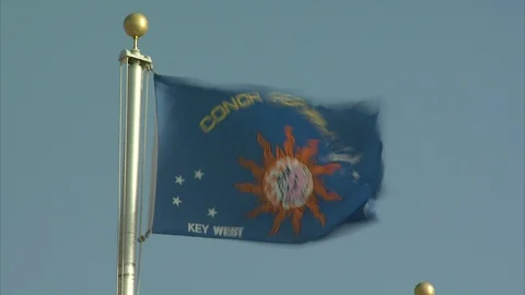 Conch Republic flag blowing in wind on flag pole Stock Footage 95601398