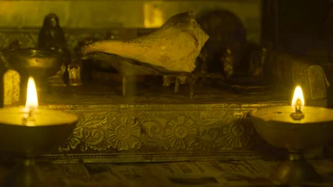 A conch shell is offered in the puja mandir 4k stable Short Video stock 252212164