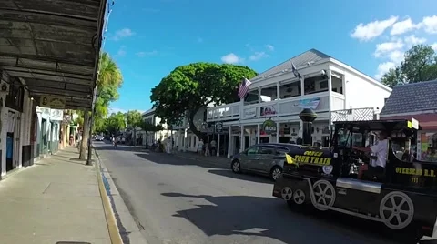 Conch train tour driving down duval street in key west, florida Stock Footage 41869346