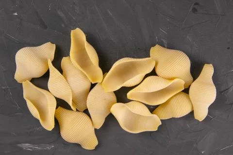 Conchiglie pasta shell composition on black background with clipping path. Co Stock Photos