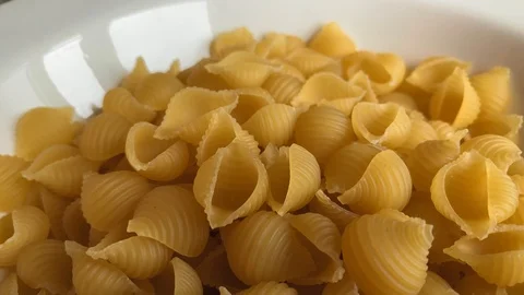 Conchiglie rigate close-up. Pasta falling into a white plate. 3840*2160 4K UHD  스톡 동영상 118369105