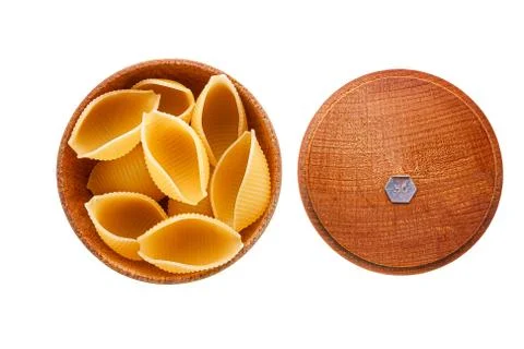Conchiglie rigate pasta or seashell macaroni in brown bowl isolated on white Stock Photos