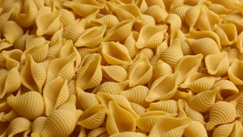 Conchiglie, Shells or Seashells Pasta Wallpaper. Spiral Raw Macaroni Stock Footage 223649664