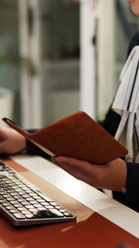 Concierge, passport and help with hands at front desk for hospitality, booking Stock Footage 335374171