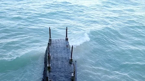 A concrete abandoned bridge at the beach Stock Footage 114591171