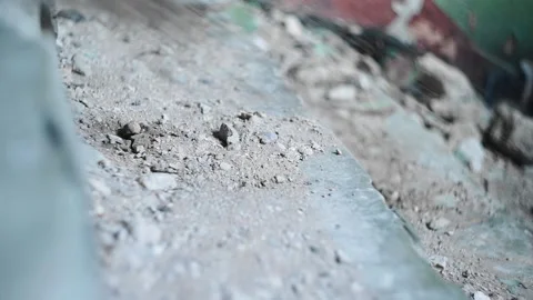 Concrete and dust fall down the steps and the man runs down the steps Video stock 230193726