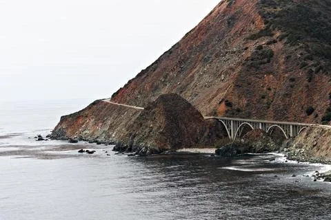 Concrete Arch Bridge Beneath Rugged Cliffs in Big Sur California Stock Photos