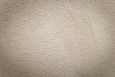 Concrete background. Plaster on the wall. Embossed textured surface. Stock Photos