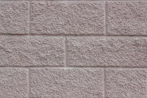 Concrete background with a rectangular pattern imitating brickwork. Stock Photos