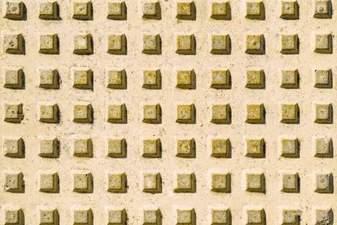 Concrete background with regular square protrusions. Background with geometric Stock Photos