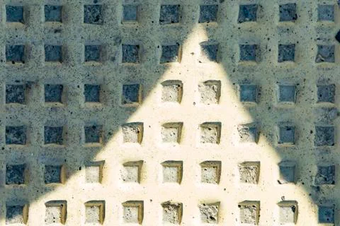 Concrete background with regular square protrusions. Background with geometric Foto stock