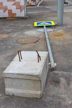 Concrete base for a road sign lying nearby Stock Photos