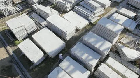 Concrete batching plant. Worker inspects a concrete slabs store. Stock Footage 18533723