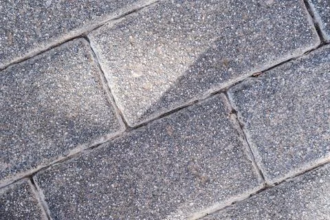 Concrete block background of old cobblestone pavement close-up. Stock Photos